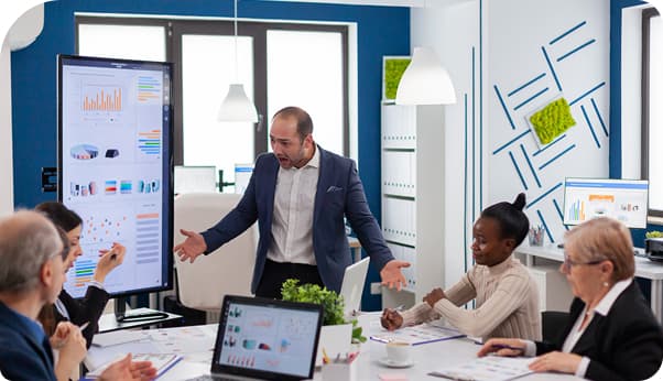 A facilitator leading a corporate training session with a group of employees