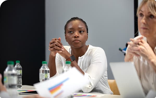 A woman attentively participating in a training workshop